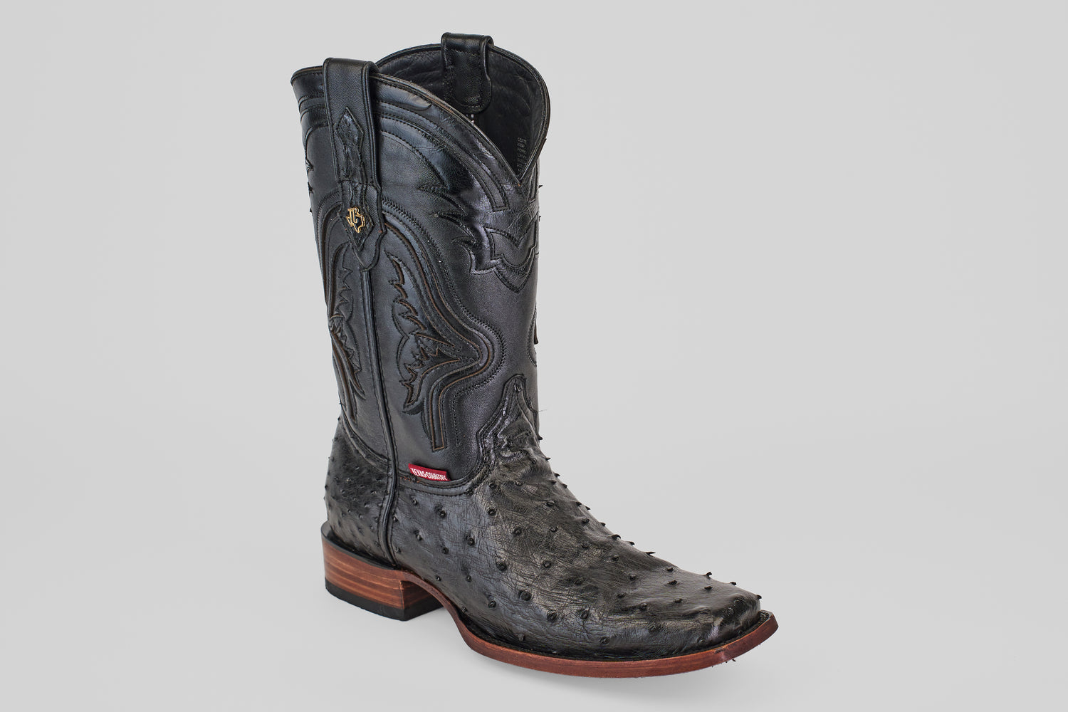 The Exotic Ostrich - Black - Rodeo Toe boot, shown solo on a light gray background, features decorative stitching, a pointed toe, and a stacked wooden heel—ideal for adding classic western flair.