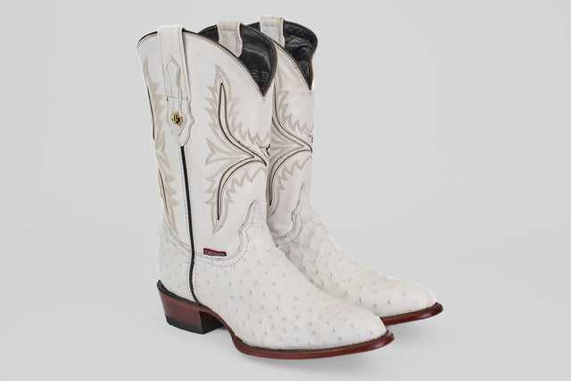 A pair of Austin - White - Round Toe boots, featuring decorative stitching, textured leather, round toes, and brown stacked heels with distinctive oval patterns, displayed on a plain light background.