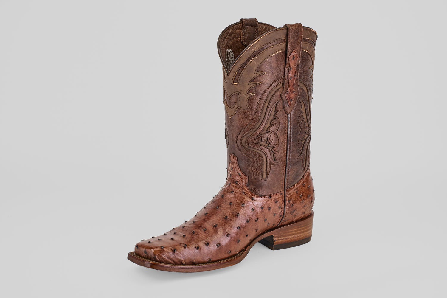 The "Austin - Brown - Rodeo Toe" boot features decorative stitching and a textured Kango Tabaco Avestruz (ostrich skin) leather pattern, displayed solo against a plain light gray background.