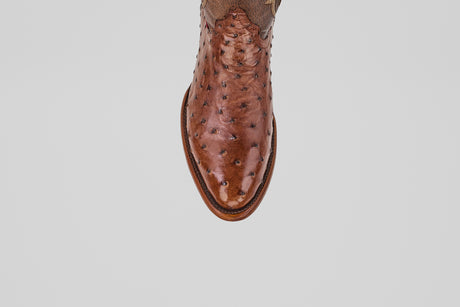 A close-up, top-down view of the toe and upper of the Austin - Brown - Round Toe cowboy boot in brown ostrich leather, shown against a plain light gray background.