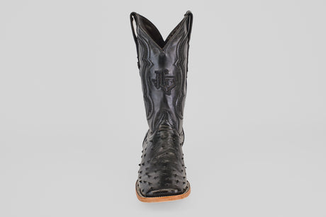 A single Austin - Black - Square Toe cowboy boot in black leather with decorative stitching and an avestruz-textured pattern on the foot, shown from the front against a plain light background.