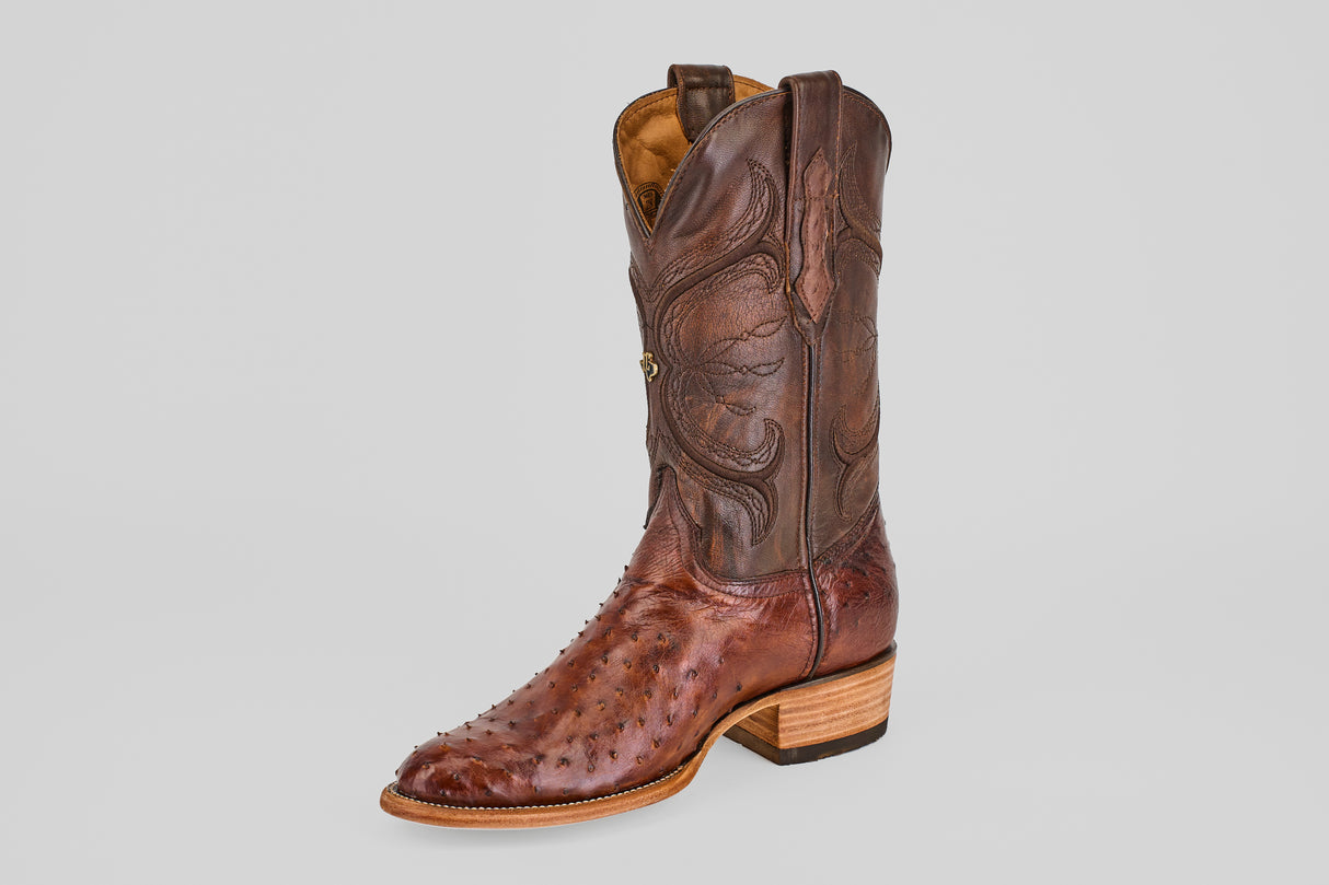 A single Austin - Tabaco - Roper Toe men’s cowboy boot in brown ostrich leather with a roper toe, decorative shaft stitching, and a wooden heel is shown on a plain light gray background.