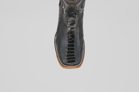 The Austin Leg - Black - Square Toe features textured black leather and detailed stitching, shown from above on a white background—these stylish boots bring a modern edge to classic Western style.