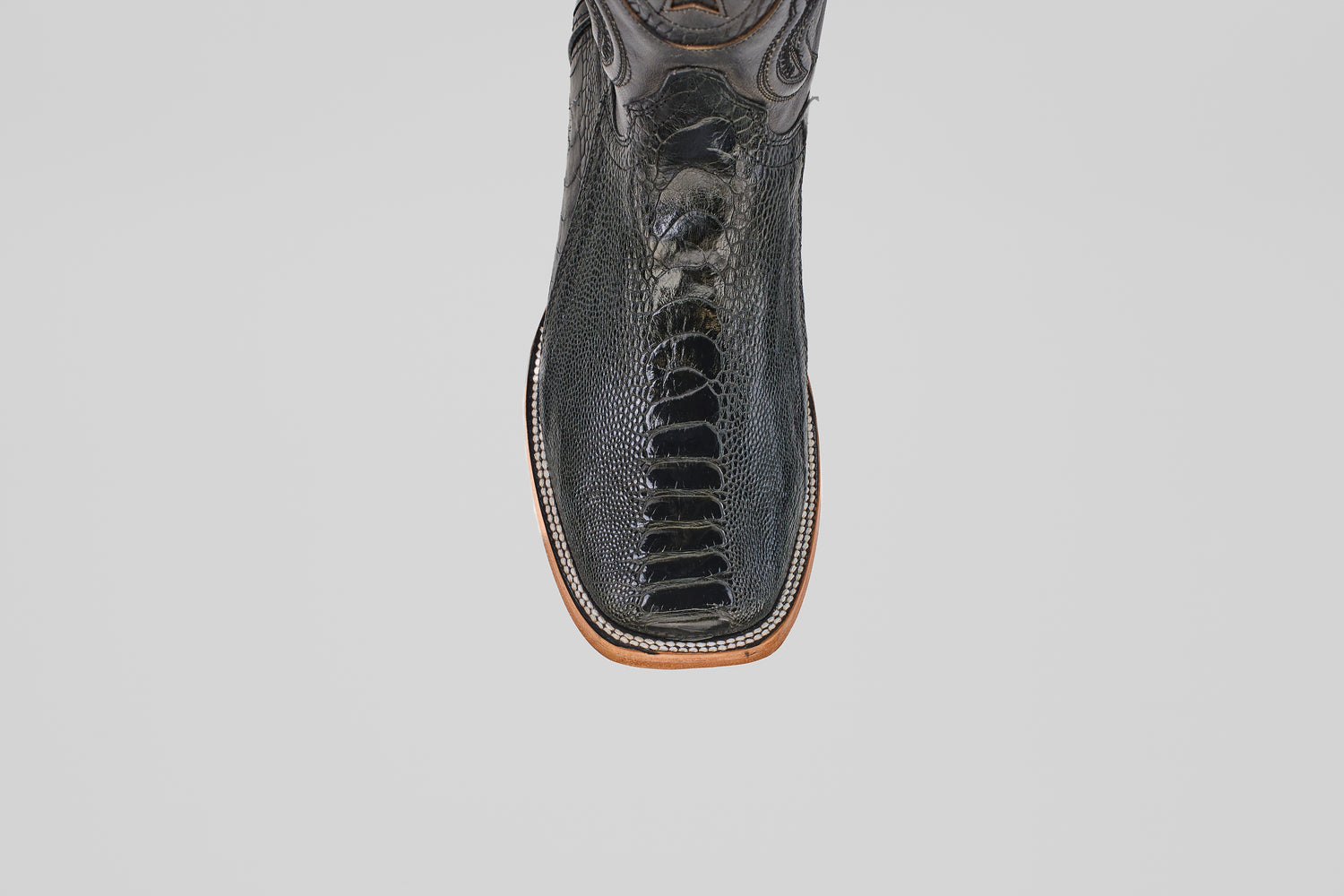 The Austin Leg - Black - Square Toe features textured black leather and detailed stitching, shown from above on a white background—these stylish boots bring a modern edge to classic Western style.