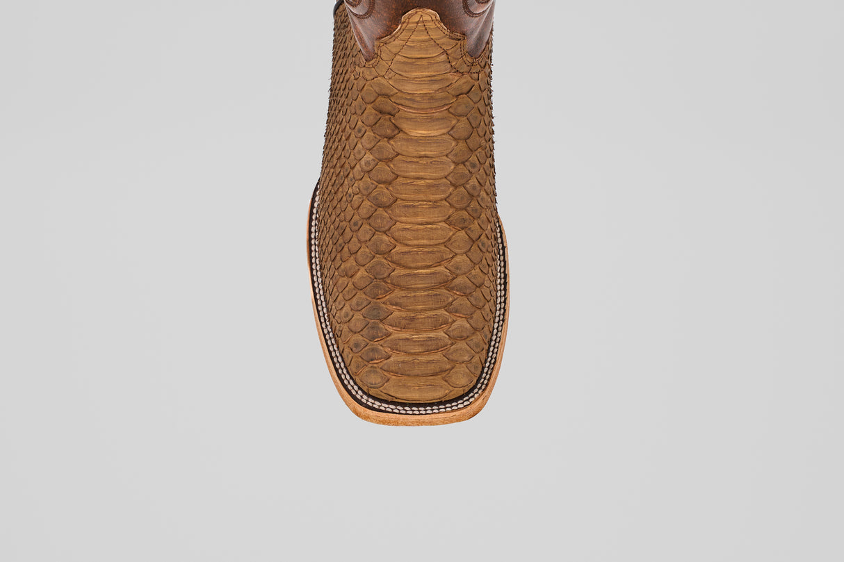 Top view of the Tanner - Tamarindo - Square Toe cowboy boot in brown Python Tamarindo leather featuring a textured snakeskin pattern and decorative stitching around the sole, displayed on a plain white background.