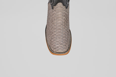 A close-up top view of the Tanner - Matte Gray - Square Toe cowboy boot in Python Gris Nobuck leather, showcasing its textured, snake-like pattern and distinctive square toe against a plain white background.