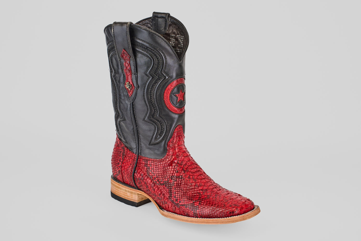 A single Tanner - Ruby - Square Toe boot with a black upper featuring a red star and a textured Python Rojo snakeskin lower, displayed on a plain light gray background.