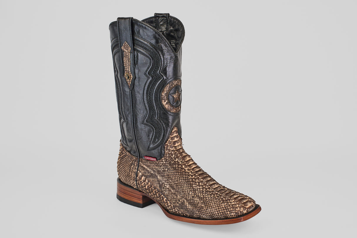 The Tanner - Rustic Bone - Square Toe boot highlights Western craftsmanship with a textured brown exotic leather foot and a tall, black stitched leather shaft, set against a plain light background.
