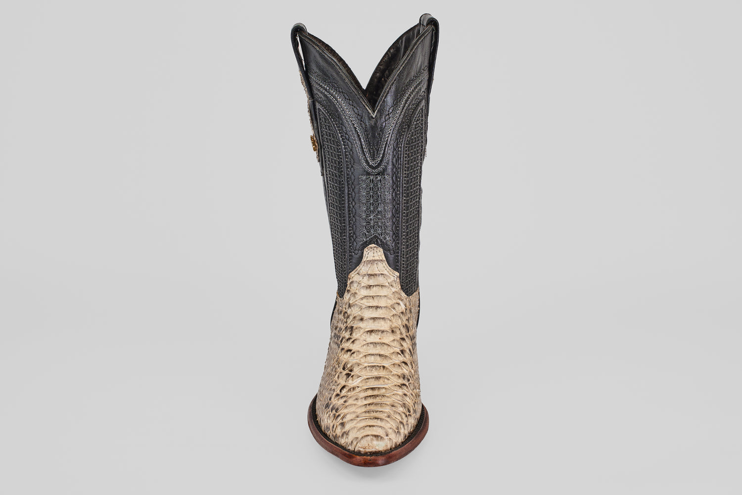 A single Tanner - Natural - Snip Toe cowboy boot, featuring a light tan Python Natural H-82 textured lower and a dark, smooth upper shaft, is displayed front-facing against a plain white background.