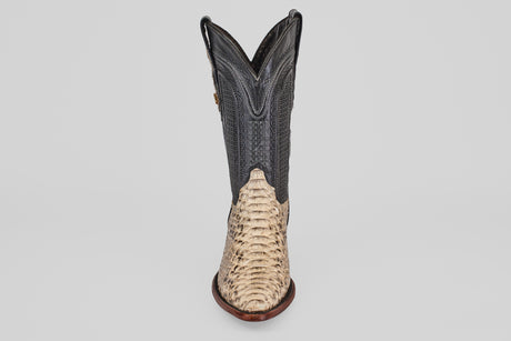 A single Tanner - Natural - Snip Toe cowboy boot, featuring a light tan Python Natural H-82 textured lower and a dark, smooth upper shaft, is displayed front-facing against a plain white background.