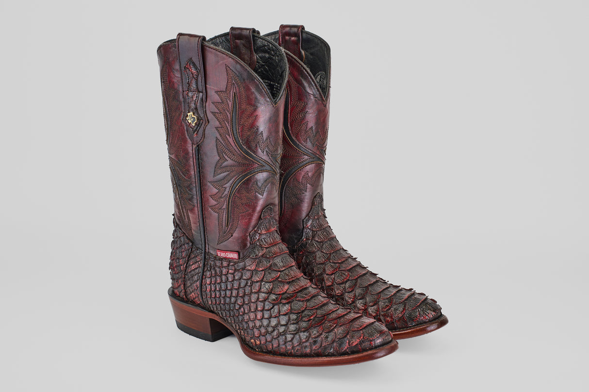 A pair of Tanner Jumbo - Black Cherry - Round Toe boots featuring tall shafts, intricate stitching, and a textured scale-like lower half, displayed against a plain light gray background.
