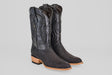 The Tanner – Matte Black – Roper Toe boots feature black, textured snakeskin-like leather, intricate shaft stitching, and light brown wooden heels and soles, shown against a plain gray background.