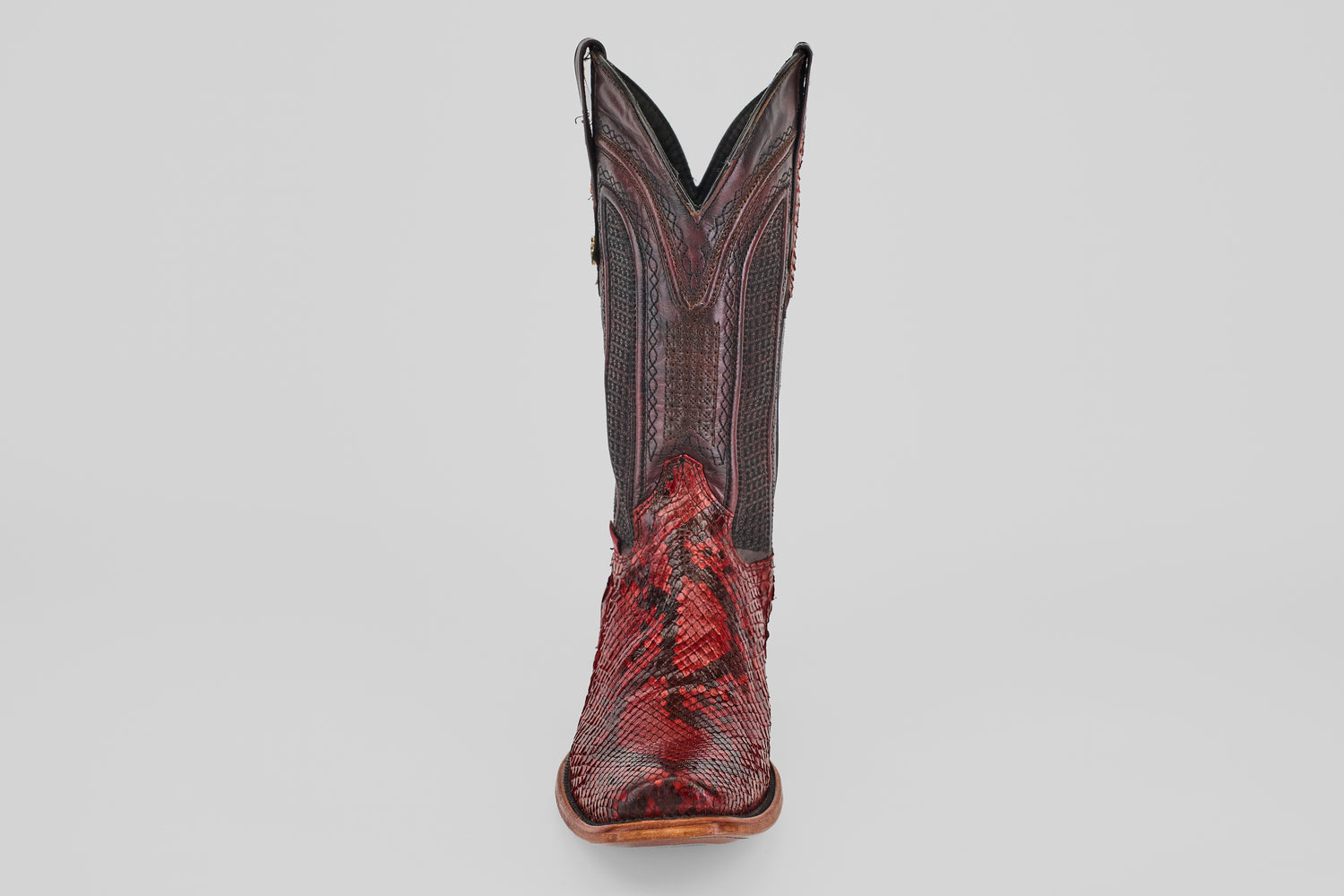 A single Tanner – Ruby – Narrow Square Toe cowboy boot in red python leather with intricate stitching, upright and facing forward against a plain white background.