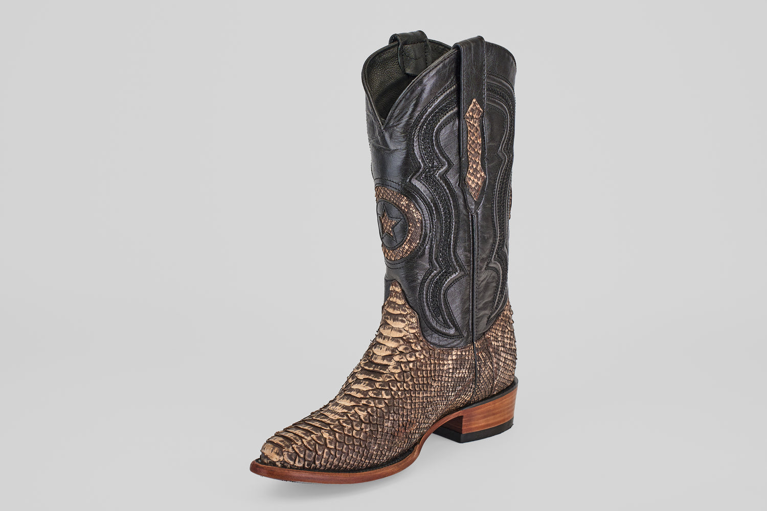 The Tanner – Rustic Bone – Snip Toe boot features a western design with a dark brown leather upper, tan python-textured leather lower and snip toe, decorative stitching, and a wooden heel, shown on a plain light background.