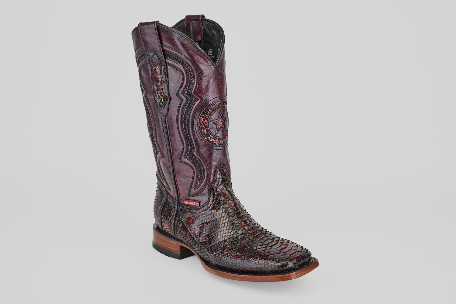 The Tanner - Black Cherry - Square Toe is a tall cowboy boot in burgundy with intricate stitching and a textured Python Blackcherry snakeskin foot, shown against a plain white background.