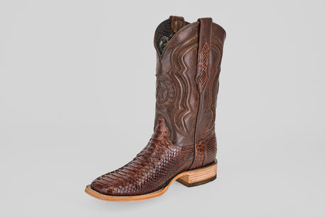 The Tanner - Brown - Square Toe boot features intricate stitching on the upper leather, a python cafe scale-like pattern on the lower part, a light wooden sole, and a square toe.