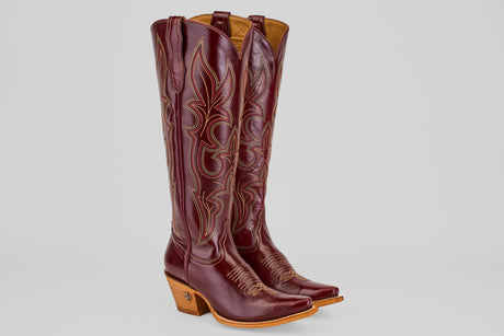 The Allison Blackberry - Tall Shaft - Snip Toe boots feature maroon leather, decorative stitching, snip toes, and light brown stacked heels, displayed on a plain light background.