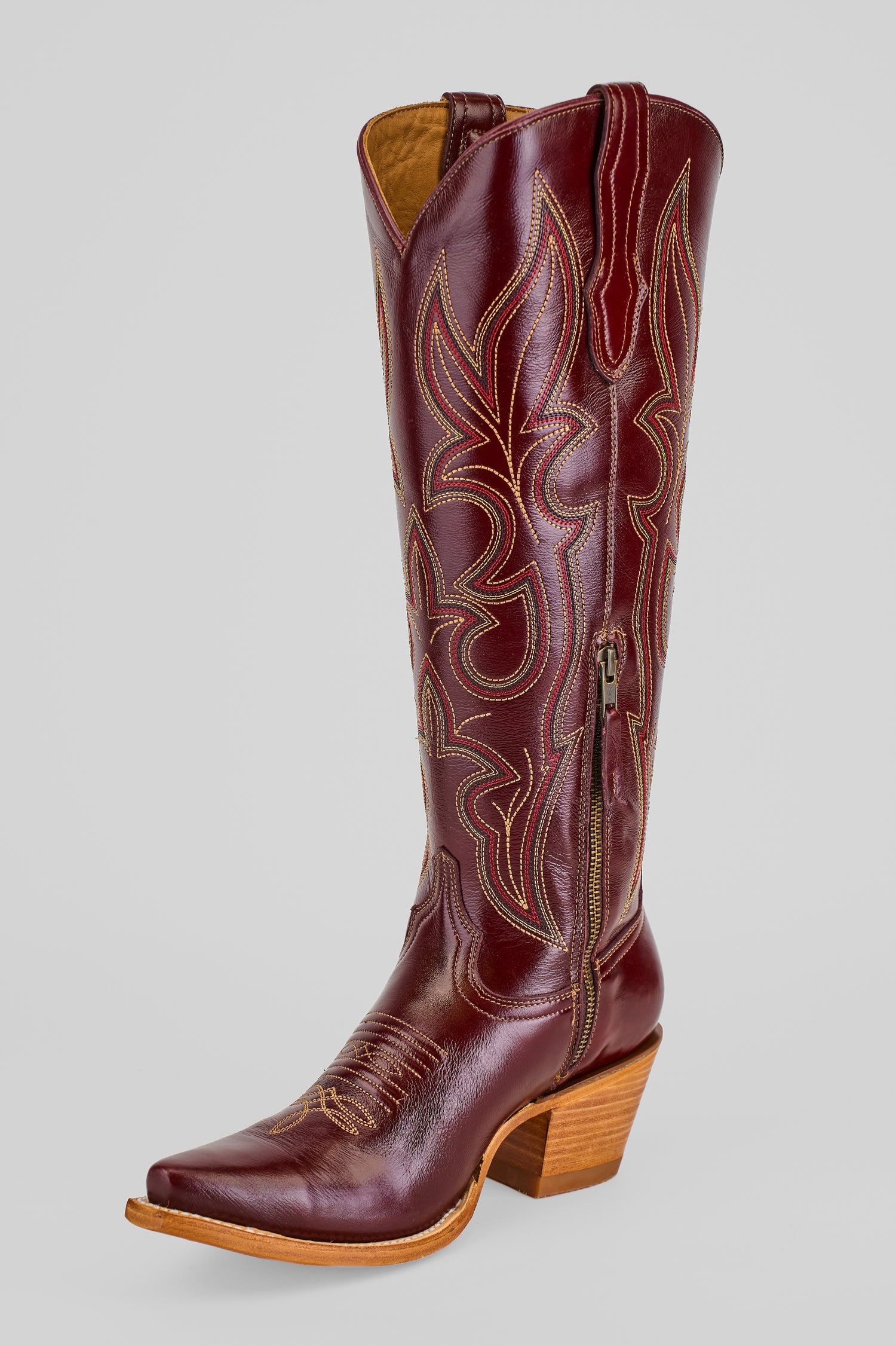 The Allison Blackberry - Tall Shaft - Snip Toe is a women's tall brown leather Western boot with decorative stitching, pointed toe, side zipper, and stacked wooden heel, shown on a plain light gray background.
