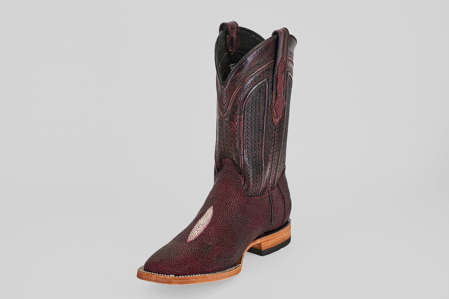 The Ranger – Wine – Square Toe boot features dark red textured stingray leather, a light brown sole, and a white toe accent, standing upright on a plain light gray background.