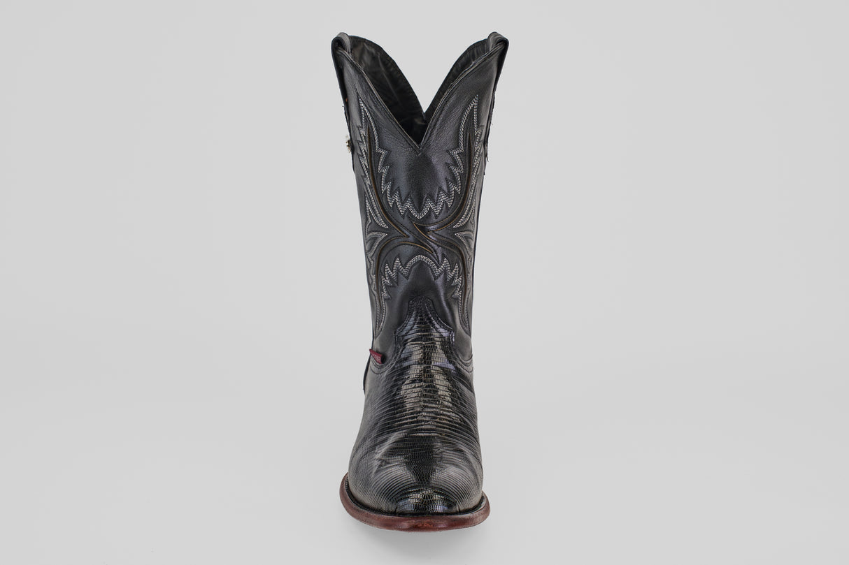 The Blaze – Black – Round Toe boot stands upright against a light gray background, showcasing its decorative stitching, round toe, and gently worn leather texture for a timeless cowboy style.
