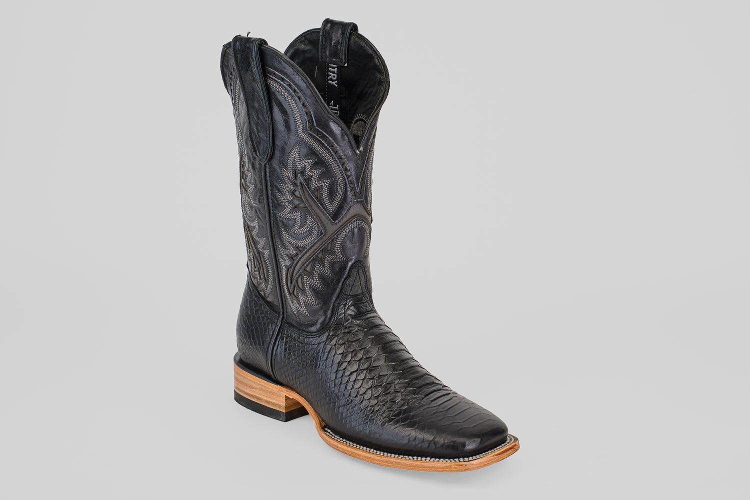 The Python Black - Embossed Leather - Square Toe (E425) boots feature a classic black design with silver details and embossed leather, offering a timeless silhouette perfect for any occasion.