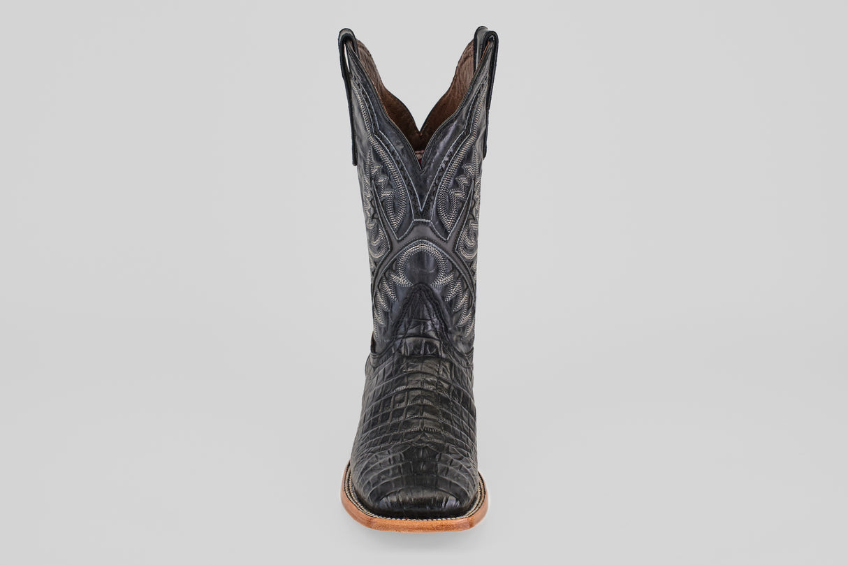 A single Caiman Belly Black - Embossed Leather - Square Toe (E423) boot featuring crocodile-like textured patterns and decorative stitching, shown front-facing against a plain light gray background.