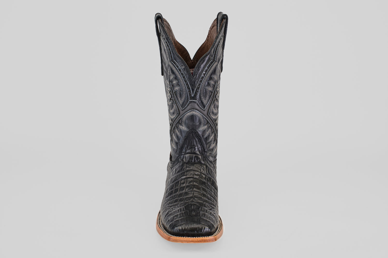 A single Caiman Belly Black - Embossed Leather - Square Toe (E423) boot featuring crocodile-like textured patterns and decorative stitching, shown front-facing against a plain light gray background.
