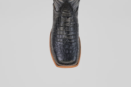 A top-down close-up of the Caiman Belly Black - Embossed Leather - Square Toe (E423) boots highlights the square toe, light brown sole, and bold black crocodile-embossed leather on a plain white background.