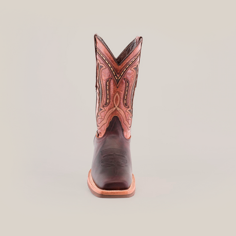 A top view of Azkar Moka boots reveals intricate stitching on the dark cowhide leather toe and an ornate design on the shaft. These boots, crafted from premium materials, feature a light brown slip-resistant sole with a visible seam around the edge.
