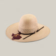 The 30X Worm - Open Crown is a wide-brimmed, light tan straw hat with a black band and decorative tag, shown on a plain background—ideal for anyone seeking unique hat styles.