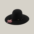 The 4X - Black - TC Hats is a wide-brimmed black Western hat with a shapeable crown, decorative black band, and maroon tag attached, displayed on a plain beige background.