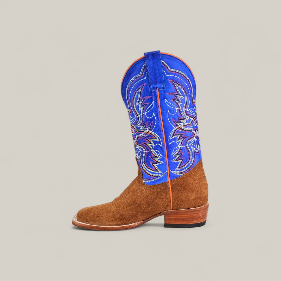 The Bronson - Gold - Square Toe mens suede boot features a brown lower half and vibrant blue shaft with multicolored stitching, blending classic and modern style. Shown in profile against a plain, light background.
