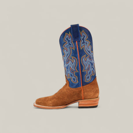 The Buck - Camel - Square Toe mens boot features a brown suede foot, a tall blue shaft with multicolored stitching, and a square toe, displayed against a plain beige background.