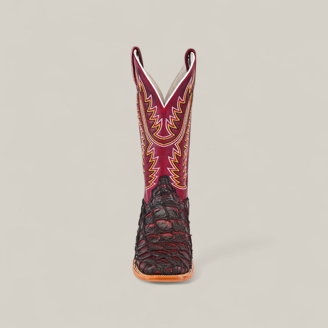 The Maverick - Wild Cherry - Square Toe boot features a dark brown textured lower, a red upper shaft with yellow and orange stitching, and a square toe, displayed facing forward against a plain light background.