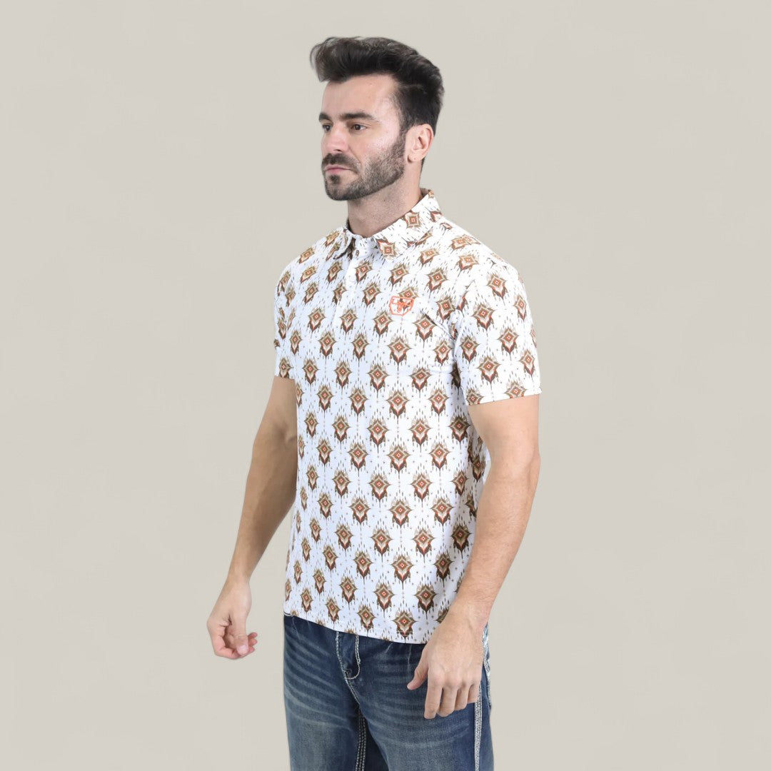 A man with short dark hair and a beard wears the Mens Performance Fabric Modern Fit Stretch Aztec Print White Polo - PGP10870 and blue jeans, standing against a plain light beige background.