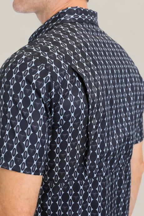 A close-up of the Mens Performance Western Short Sleeve Aztec Print Navy Shirt (PGW10646), focusing on the back and shoulder to highlight the vented flap and geometric navy Aztec print design.