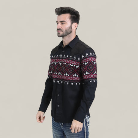 A man wears the Mens Western Modern Fit Cotton/Spandex Long Sleeve Black Shirt with Snaps (WPL10750) and blue jeans, standing against a plain light beige background.