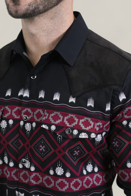 A man wears the Mens Western Modern Fit Cotton/Spandex Long Sleeve Black Shirt with Snaps (WPL10750), featuring a modern fit, bold maroon, white, and gray geometric chest pattern, black suede shoulder accents, and a pointed collar.