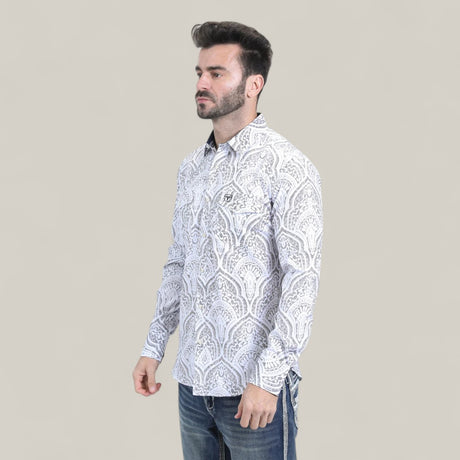 A man with short dark hair and a trimmed beard models the Mens Western Modern Fit Cotton/Spandex Long Sleeve White Shirt with Snaps (WPL10822), paired with blue jeans, standing against a plain light gray background.