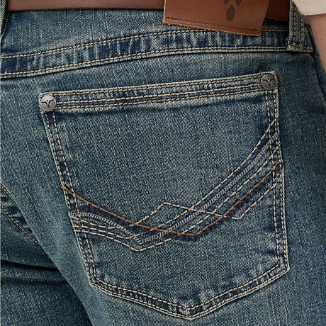 Close-up of the Wrangler Mens 20X Extreme Relaxed Fit Jeans - 1044MWXMA shows a back pocket with decorative stitching, brown leather belt at the waist, and a branded leather patch. These premium denim jeans boast a slightly faded look, offering relaxed fit and ultimate comfort.