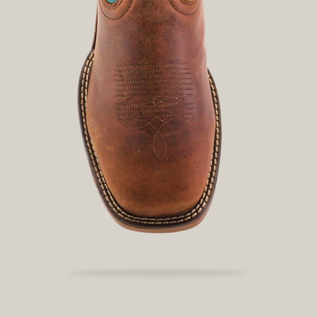 Close-up of the handcrafted Rustic Turquoise Brown boot featuring decorative stitching. It showcases a square toe and stitched welt, highlighting detailed craftsmanship with premium cowhide leather, set against a plain background.