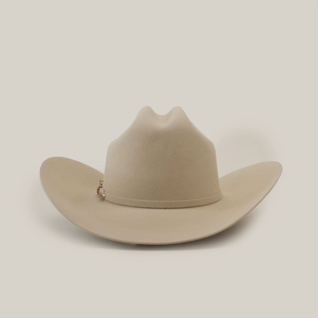 A beige western hat featuring a wide brim and slight crease at the crown, set on a plain white background. A small decorative band encircles the base, highlighting its genuine Larry Mahan 1000X Imperial Belly craftsmanship.