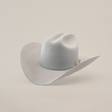 The 10X Jerarca Platinum, a gray fur felt cowboy hat with a wide brim and decorative band, exudes classic western style against a plain white backdrop.