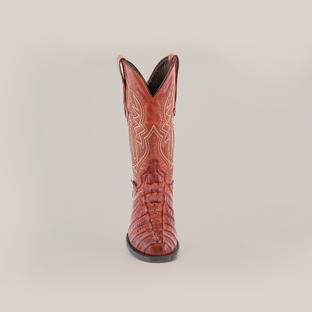 A single Crocodile Tail Print Cogñac boot is displayed against a white background, featuring intricate stitching, a round toe, decorative patterns along the shaft, and a premium leather sole for comfort and durability.