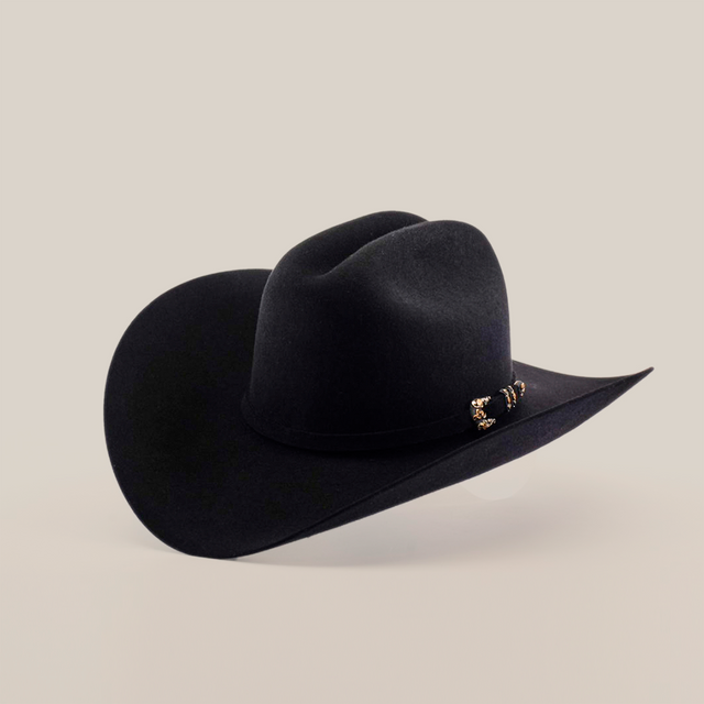 The 10X Jerarca Black hat, a fur felt cowboy style with a wide brim and decorative band adorned with metal accents, epitomizes handcrafted western headwear and is displayed against a plain white background.