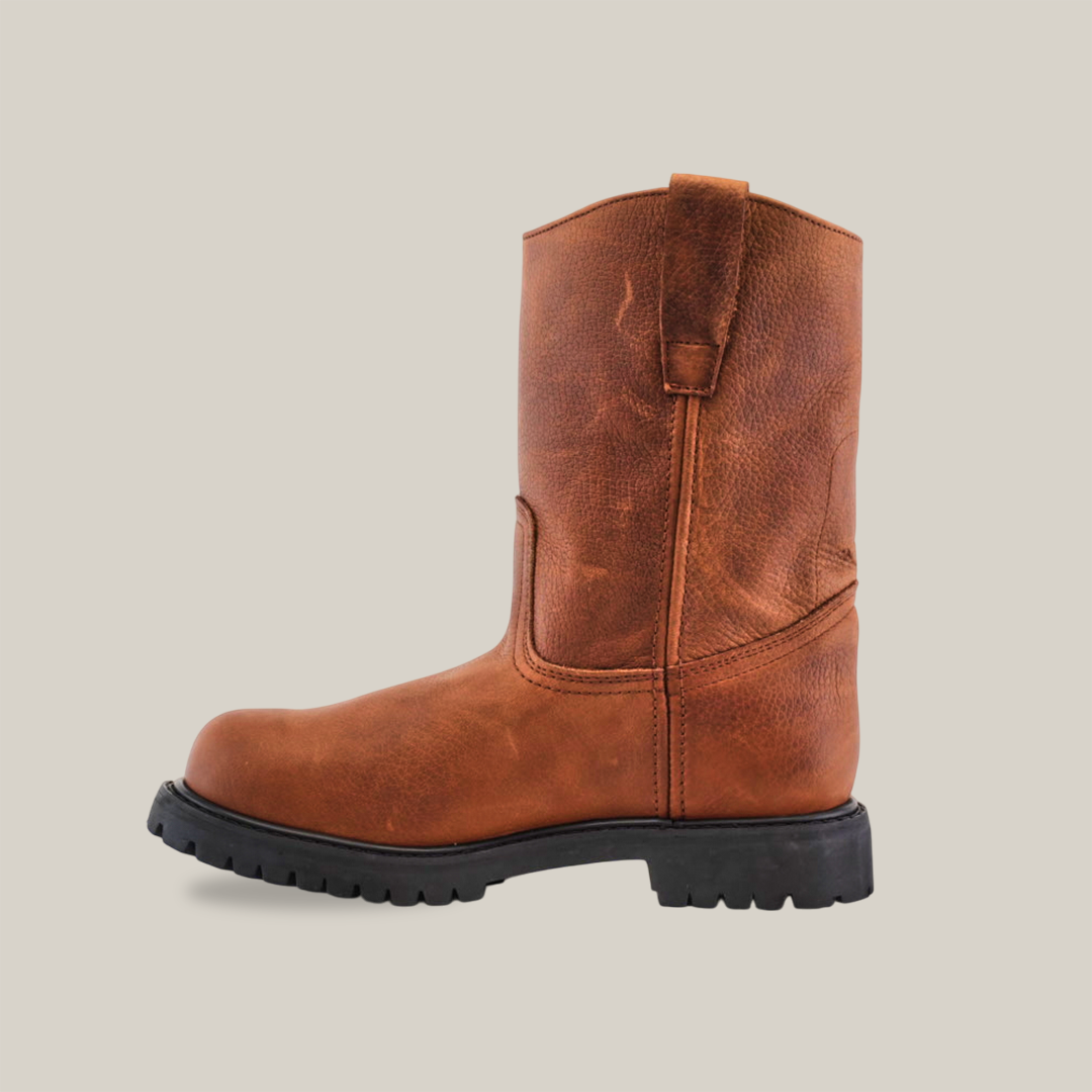 The Brandy Roper - Tractor Sole - Soft Toe boot, crafted from premium cowhide leather in a rugged brown texture, features a black tractor sole and pull tab. It is shown in side profile on a white background with a round toe design.