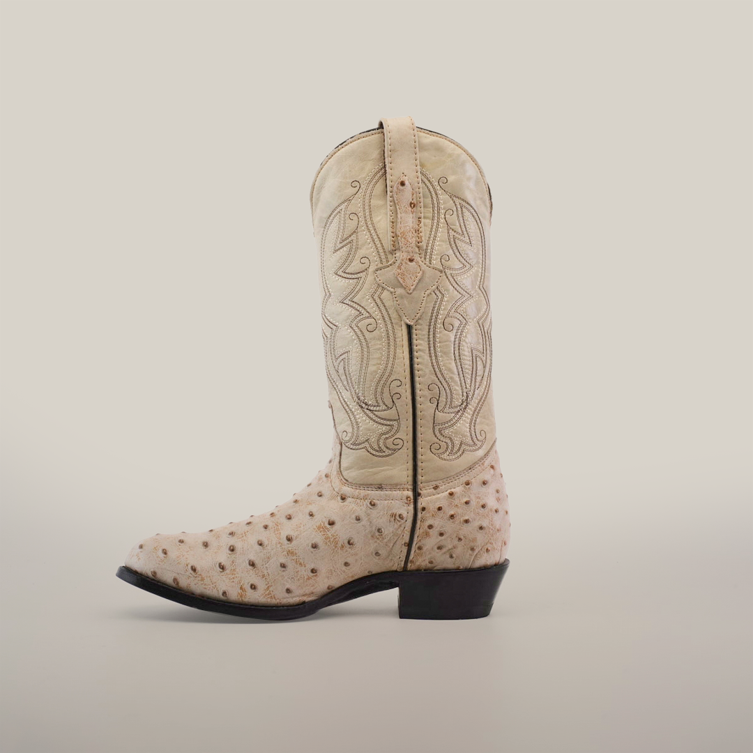 The Karoo Ostrich Print Bone - Round Toe is a single, light-colored cowboy boot with ornate stitching and a textured ostrich print surface, featuring a low heel and leather sole on a plain white background.