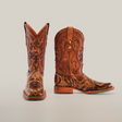 A pair of Handtooled Leave Orix cowboy boots with detailed engravings, made from premium cowhide leather. The left boot stands upright while the right reveals its slip-resistant sole on a plain white background.