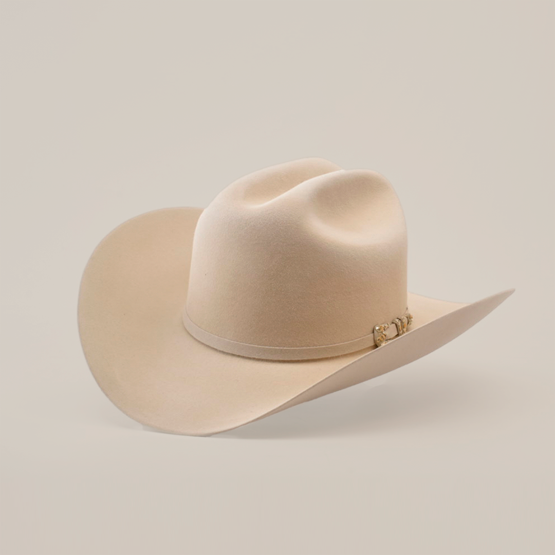 A light beige cowboy hat with a wide brim and a subtle decorative band, set against a plain, light background.