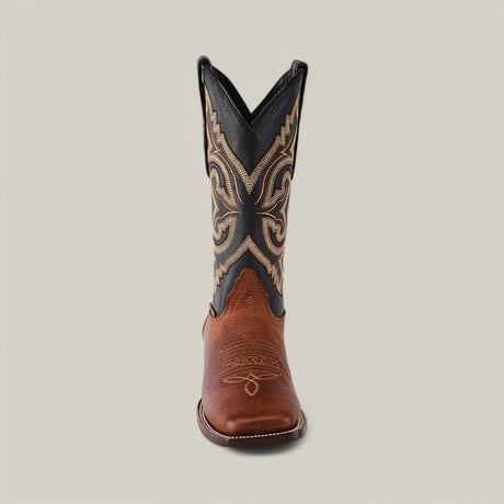 The Grisly Tan - Square Toe boot, made from premium leather, features a brown foot and tall black shaft with intricate tan swirling embroidery, embodying Western style against a neutral backdrop.